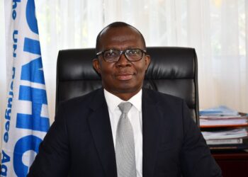Matthew Kwesi Crentsil, Ghanaian humanitarian leader and UNHCR veteran, seated at his office desk.