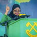Tanzanian President Samia Suluhu Hassan addresses supporters during a campaign rally in Dar es Salaam, amid criticism of restrictions on opposition candidates.
