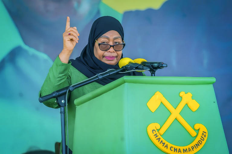 Tanzanian President Samia Suluhu Hassan addresses supporters during a campaign rally in Dar es Salaam, amid criticism of restrictions on opposition candidates.