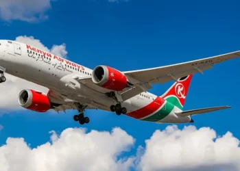 A Kenya Airways aircraft taking off against a blue sky, symbolising air travel connectivity in Africa