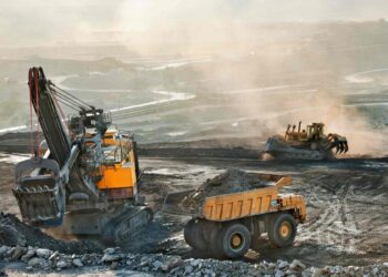 Heavy machinery operating at an African open-pit mine extracting critical minerals for global green energy transition.