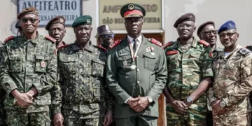 Senior military officers in uniform stand in formation outside a government building in Bissau, with General Horta Nta Na Man positioned at the centre after the Guinea-Bissau coup