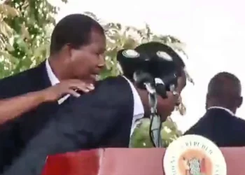 Zambia’s president is rushed from a podium by security officers as objects are thrown during unrest in Chingola.