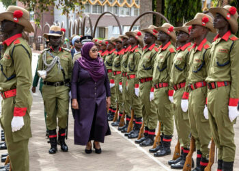 President Samia Suluhu Hassan inspecting an honour guard during a ceremony outside parliament in Tanzania.