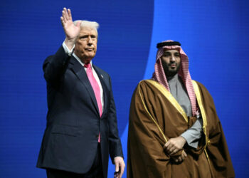 US President Donald Trump waves while standing beside Saudi Crown Prince Mohammed bin Salman during an event