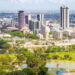 Aerial view of Nairobi city skyline with lush green parks, showcasing urban development and tree cover efforts against rising heat.