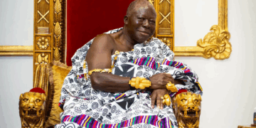 Asantehene Otumfuo Osei Tutu II seated on his golden throne at the Manhyia Palace in Kumasi, adorned in traditional kente and gold regalia.