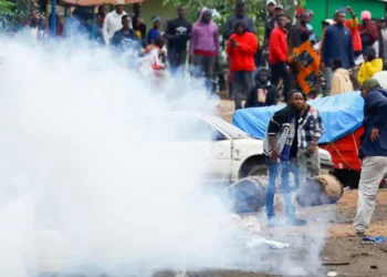 Protesters run through tear gas during post-election unrest in Dar es Salaam, Tanzania.