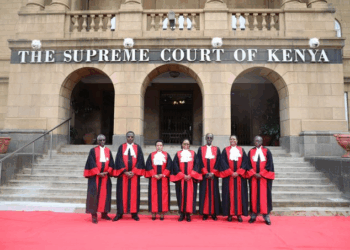 Judges of the Supreme Court of Kenya stand in their official robes on the steps of the Supreme Court building in Nairobi.