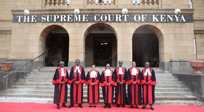 Judges of the Supreme Court of Kenya stand in their official robes on the steps of the Supreme Court building in Nairobi.