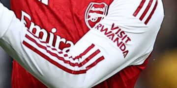 Arsenal player’s shirt showing the ‘Visit Rwanda’ logo on the sleeve during a match.