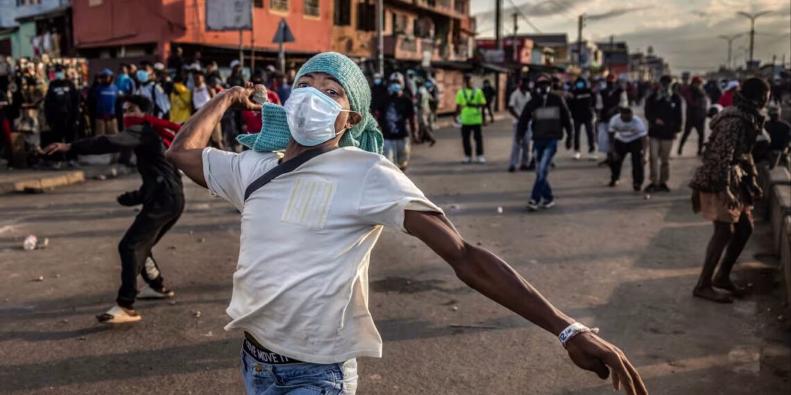 Young Malagasy demonstrators wave flags and chant during anti-government protests in Antananarivo, symbolising Africa’s rising Gen Z-led movements demanding accountability and better governance.