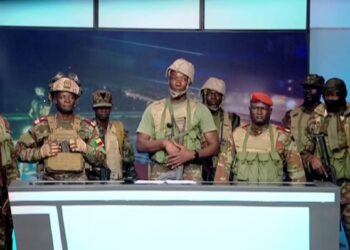 A group of Beninese soldiers in uniform read a statement on national television during a brief attempted coup in Cotonou