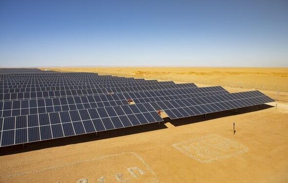 Large aerial view of the Cazombo solar farm in Angola, showing extensive solar panels and battery storage units in a rural landscape
