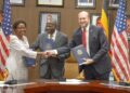 US Ambassador William W. Popp shakes hands with Ugandan health officials during the signing of a $2.3bn US–Uganda health cooperation agreement, with Minister Matia Kasaija present