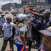 Police officers block Operation Dudula supporters during a protest outside a clinic in South Africa, where the group has tried to stop undocumented migrants from accessing healthcare