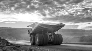 Heavy-duty haul truck transporting bauxite ore at a mining site in Guinea
