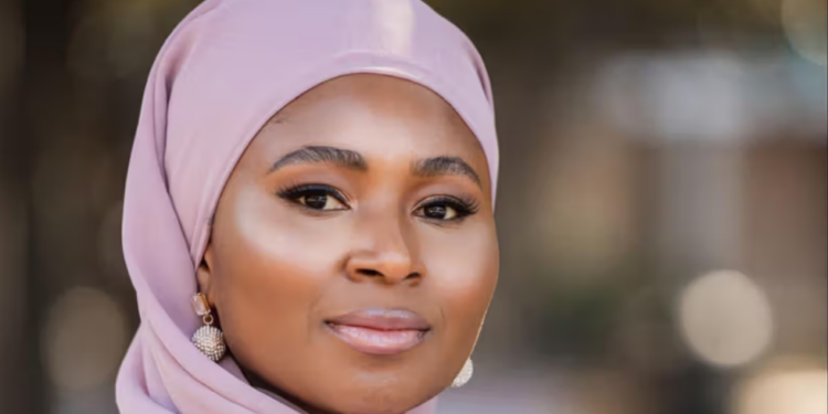 Portrait of Ghanaian entrepreneur Latifa Seini, founder of an ethical e-commerce marketplace, wearing a pink headscarf.