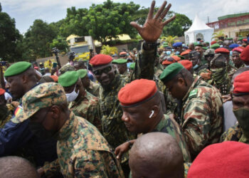 Guinea’s military leader Mamady Doumbouya surrounded by armed soldiers wearing red and green berets during a public appearance in Conakry