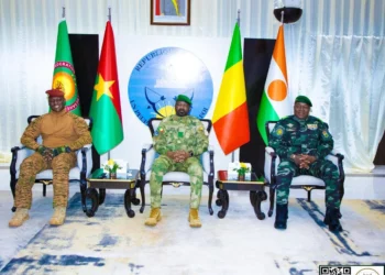 Military leaders of Burkina Faso, Mali and Niger seated beneath national flags during a joint official meeting in Niamey.
