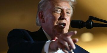 President Donald Trump speaking at a rally, pointing while addressing supporters.