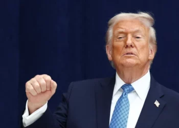 US President Donald Trump speaking with fist raised during a public appearance