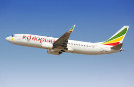 Ethiopian Airlines Boeing aircraft flying against a clear blue sky