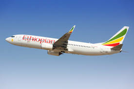 Ethiopian Airlines Boeing aircraft flying against a clear blue sky