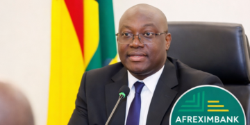 Ghana’s Finance Minister Cassiel Ato Forson speaking at a press briefing, with the Ghana flag and Afreximbank logo visible, announcing the resolution of a $750m financing deal