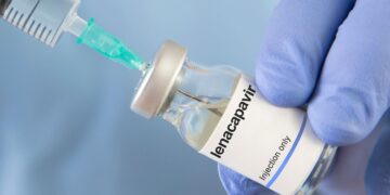 A gloved healthcare worker draws lenacapavir from a vial into a syringe ahead of HIV-prevention injection.