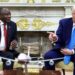 South African President Cyril Ramaphosa and US President Donald Trump talking during a meeting in the Oval Office, seated facing each other with a model aircraft in the foreground