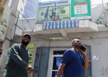 Somali pedestrians walk past shops and a forex bureau in Mogadishu’s Hodan district after President Donald Trump made derogatory comments about Somalia.