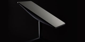 Starlink satellite internet terminal mounted on a stand against a dark background