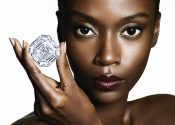 African woman holding a polished diamond, symbolising Botswana’s diamond industry and global trade significance