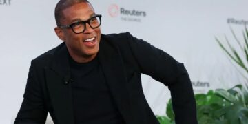 Former CNN anchor Don Lemon speaking during a public interview event, smiling while seated on stage against a Reuters backdrop
