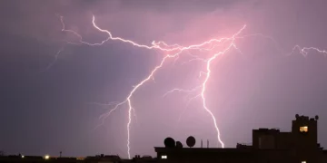Lightning forks across the night sky above buildings during a severe thunderstorm near Pretoria, South Africa