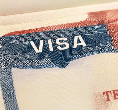 Close-up of a United States immigrant visa page highlighting the word ‘VISA’ amid tighter US immigration controls affecting African countries