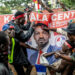 Supporters gather around a campaign banner of Ugandan opposition leader Bobi Wine during post-election unrest following President Museveni’s re-election