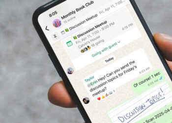 Smartphone displaying a WhatsApp group chat with an event reminder and tagged message in a discussion group