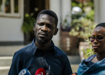 Ugandan opposition leader Bobi Wine speaks to journalists alongside his wife during a media briefing in Kampala following the disputed 2025 election.