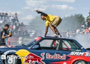 IShowSpeed performing a stunt atop a drifting car during his Africa tour, drawing crowds as fans film the viral moment.