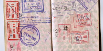 Open African passport showing multiple entry and exit stamps from Zambia, Botswana and Zanzibar.