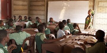 Nigerian primary school pupils attend an English-language lesson in a classroom, highlighting education quality and language learning outcomes