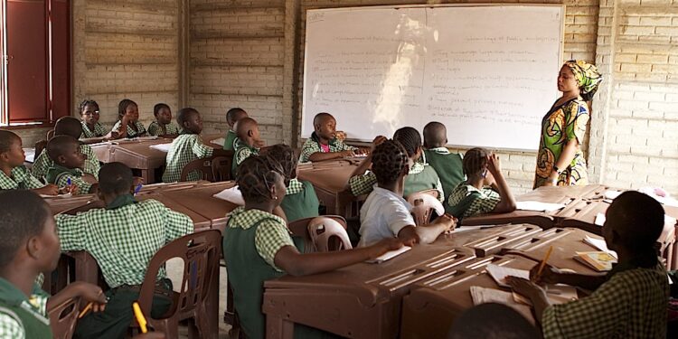 Nigerian primary school pupils attend an English-language lesson in a classroom, highlighting education quality and language learning outcomes