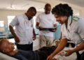 Healthcare workers attend to patients at a public clinic in Chiradzulu, Malawi, as part of nationally managed health services