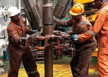 African oil and gas workers operate drilling equipment at an offshore energy facility, highlighting Africa’s expanding energy exports amid global trade shifts.