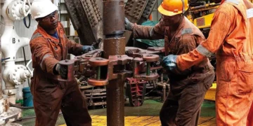 African oil and gas workers operate drilling equipment at an offshore energy facility, highlighting Africa’s expanding energy exports amid global trade shifts.