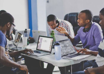 Young African software developers collaborating at a tech workspace in Zanzibar