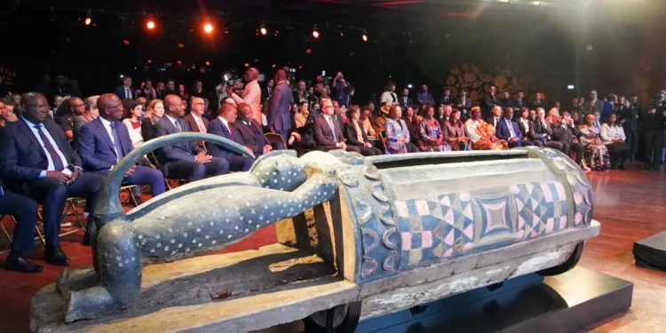 Djidji Ayokwe talking drum returned by France displayed during official restitution ceremony attended by French and Cote d’Ivoire officials in Paris