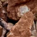 Artisanal miner standing among large rock formations at a mineral site in the Democratic Republic of the Congo, highlighting the country’s vast critical mineral reserves.